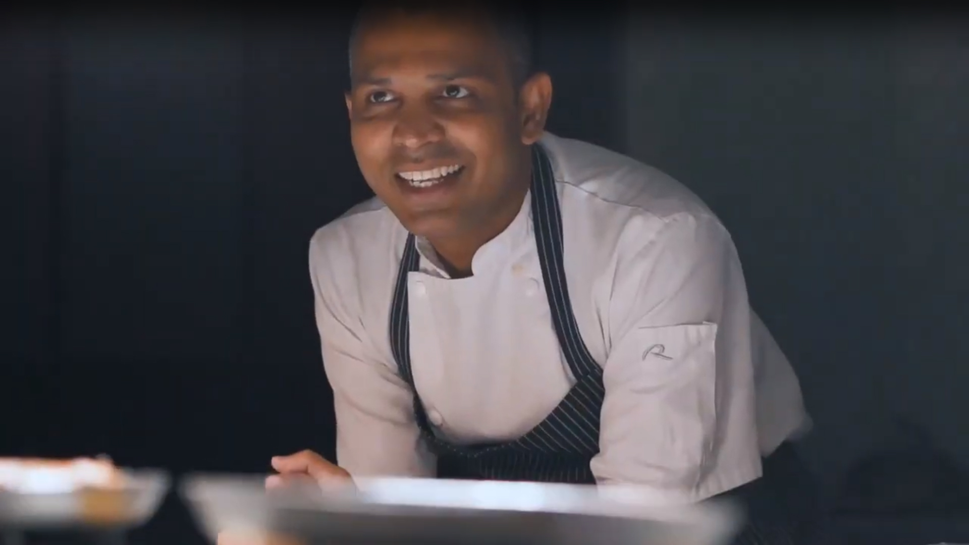 A picture of a chef smiling.